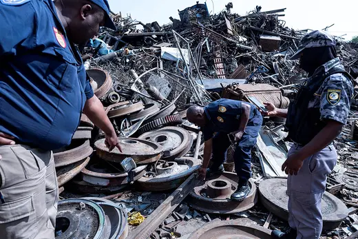 Johannesburg Metro Police Department officers discover railway infrastructure in a scrapyard during a raid on a highjacked property in Johannesburg on September 6, 2023. 